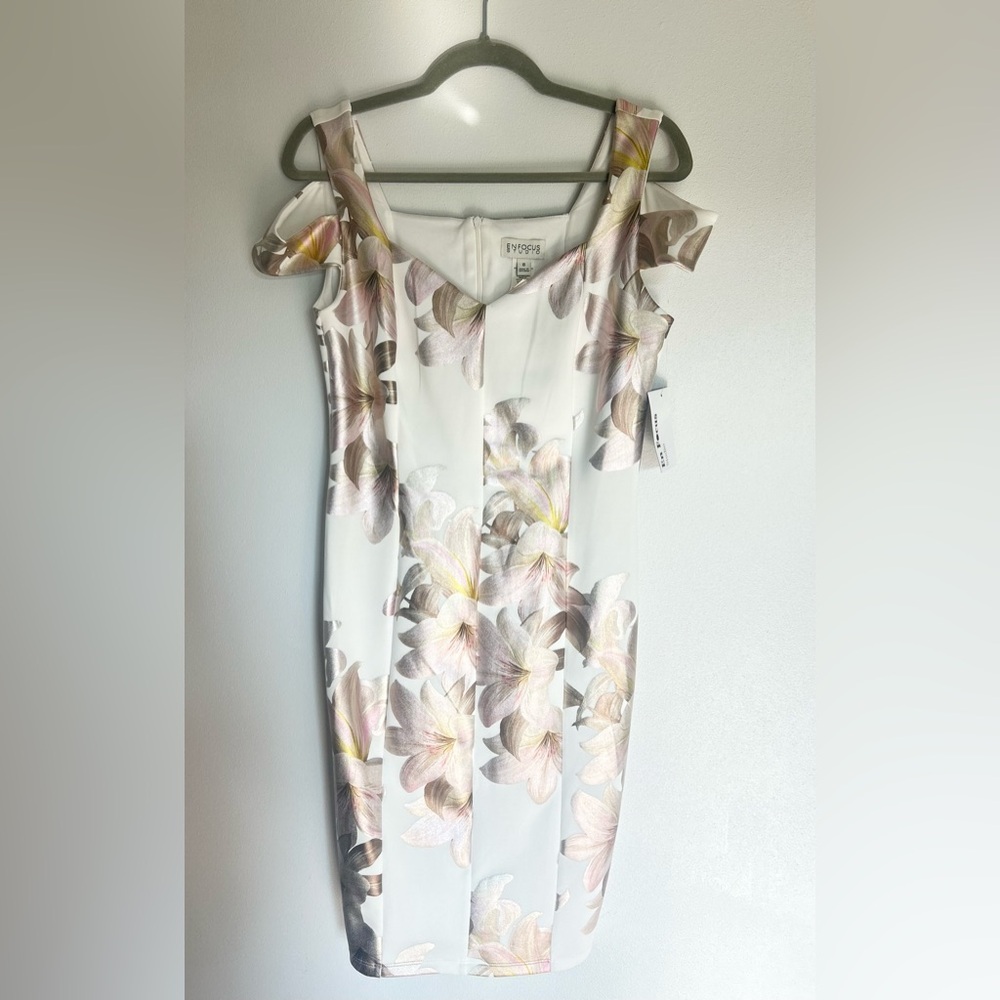 Beautiful, white dress with iridescent florals. Perfect for your wedding shower.